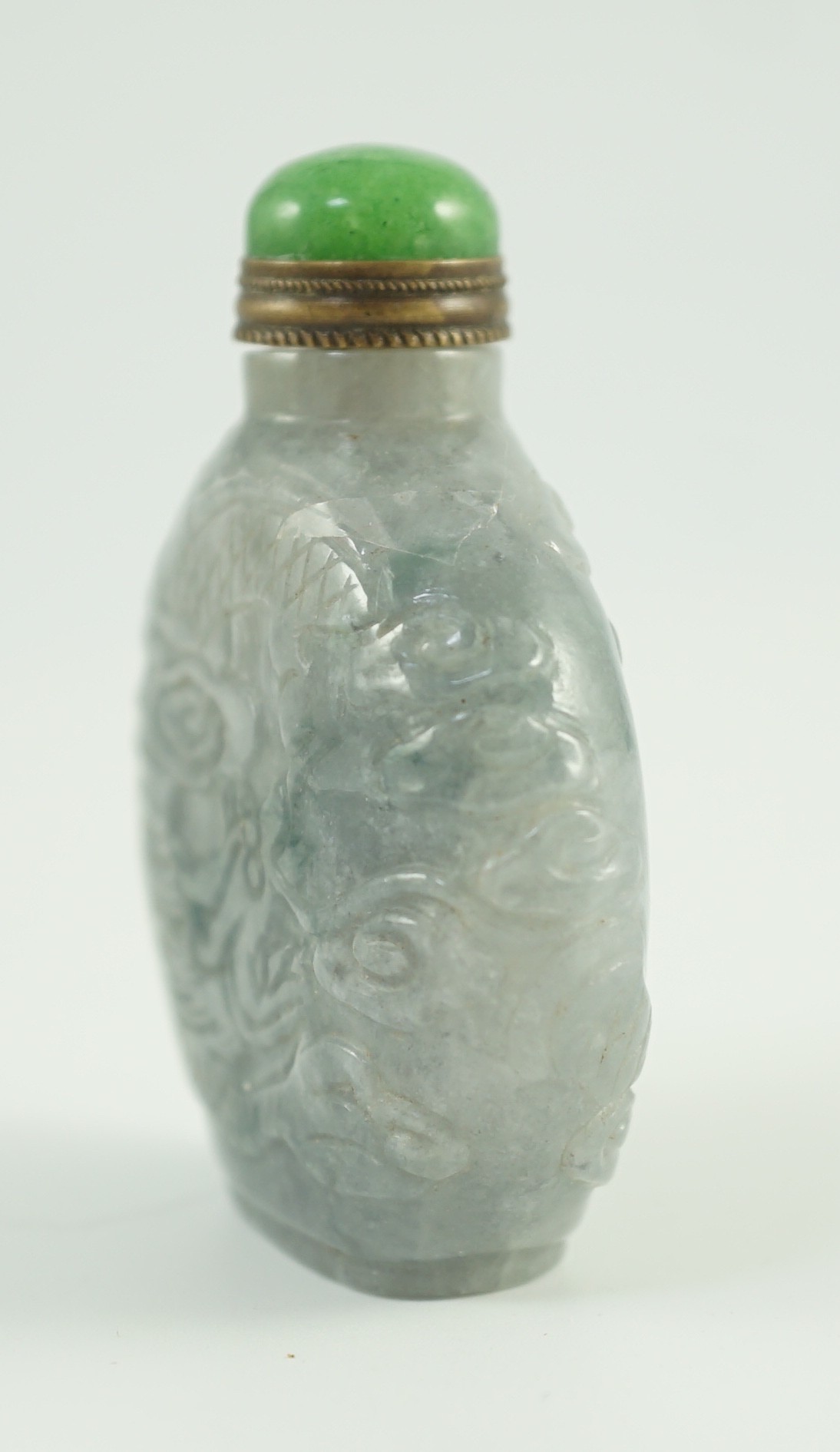 A Chinese jadeite ‘dragon’ snuff bottle, c.1800-1900, 4.9cm high, jadeite mounted stopper